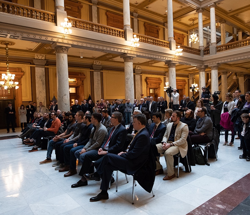 Delegates seated at a high-level policy gathering in a government building
